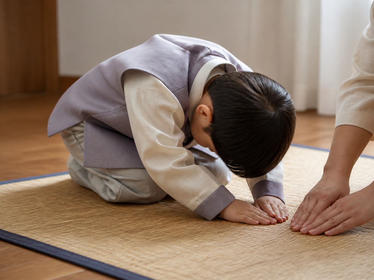 Seorang anak belajar mengulangi gerakan membungkuk dalam, membungkuk sedang, dan membungkuk setengah secara perlahan dalam posisi berpegangan tangan di ruang tamu bersama ibunya.